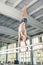 Male gymnast performing handstand on parallel bars