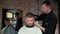 Male haircut with electric razor. Close up of man hair cut. Male hands barber shaving man with electric razor in