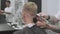 Male haircut with electric razor. Hair trimmer hairstyle in slow-mo