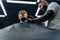 Male haircut with electric razor. Tattooed Barber makes haircut for client at the barber shop by using hairclipper. Man