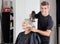 Male Hairdresser With Dryer Setting Customer\'s