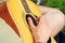 Male hand on acoustic guitar outdoor rustic atmospheric simple photo