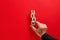 Male hand arranging the wooden blocks with the word team on red background. Team formation, cooperation or corporate team building