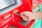 Male hand businessman inserts credit card into the ATM