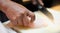 The male hand of Chef sliding fish on chopping board prepare to cooking in the kitchen at the restaurant