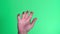 Male hand clenched on a green background of the color key screen. Interface concept.