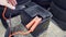 The male hand connects the terminals to the car`s batteries. A man throws and removes the terminals on the battery