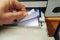 Male hand counting the stack of white paper in laser printer