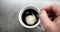 Male hand cup of Hot coffee Closeup Top view. Business and Drink Concepts. Top view of person hand stirring coffee with