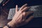 Male hand on desk with finger on computer keyboard