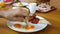 Male hand dip bread in fried egg yolk in restaurant or cafe, breakfast or lunch