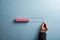 Male hand drawing a loading bar with pink wooden blocks representing the progress