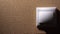 Male Hand Finger Pushes the Light Switch. Home comfort concept