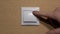 Male Hand Finger Pushes the Light Switch. Home comfort concept