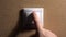Male Hand Finger Pushes the Light Switch. Home comfort concept