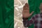 Male hand with a gesture of protest, vows against the background of the silk national flag of Nigeria, concept of denial and