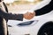 Male hand gives a car keys to male hand in the car dealership close up. Unrecognized auto seller and a man who bought a