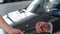Male hand gives a car keys to man hand in the car dealership close up. Unrecognized auto seller and a woman who bought a
