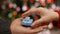 Male hand giving christmas present to female hand - closeup