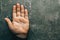 Male hand on gray table with open palm, top view. Palmistry concept