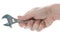 Male hand holding the adjustable spanner isolated