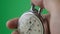 Male hand holding analogue stopwatch on green screen chroma key. Time start with old chronometer man presses start