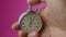 Male hand holding analogue stopwatch on pink background. Time start with old chronometer man presses start button in the