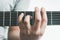 Male hand holding a barre chord on the acoustic guitar, close-up