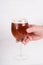 Male hand holding a glass of homemade craft beer on white background.  Ale or lager from pilsner malt