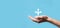 Male hand holding icon with three directions icon on blue background. Doubt, having to choose between three different choices