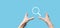 Male hand holding magnifying glass ,search icon on blue background. Concept search engine optimization, customer support.Browsing