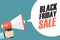 Male hand holding megaphone with Black Friday Sale speech bubble. Banner for business, promotion and advertising.