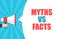 Male hand holding megaphone with Myths vs facts speech bubble. Loudspeaker. Banner for business, marketing and