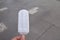 A male hand holding a melting coconut milk ice cream on wooden stick  ound