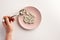 Male hand holding spoon with pills. Plate with pills