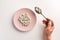 Male hand holding spoon with pills. Plate with pills.