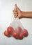 Male hand holding tomatoes in a reusable ecobag