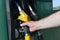 Male hand holding  yellow fuel pump