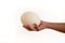 Male hand holds of big ostrich egg on white background, size comparison, close up. Organic fresh egg. Healthy food. Ostrich egg.