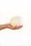 Male hand holds of big ostrich egg on white background, size comparison, close up. Organic fresh egg. Healthy food. Ostrich egg.