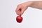 Male hand holds red apple. Health and nutrition concept.