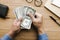 Male hand holing money dollar bill on wood table.