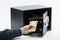 Male hand keeping euro banknotes in a safe deposit box