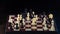 Male hand making move with white horse knight on chess board isolated over black background. Businessman playing chess