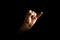 Male hand making pinky swear sign over dark background. The concept of friendship, quarrel, human relationships. copy