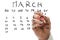 Male hand marking on calendar the date of March 8