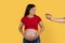 Male Hand Offering Plate With Croissant To Happy Pregnant Lady