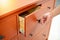 Male hand opening drawer on wooden cabinet