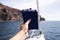 Male hand with passports and air tickets against rock, Atlantic ocean and blue sky in Maspalomas, Gran Canaria