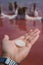 Male hand piece salt on pink water - extraction sea salt